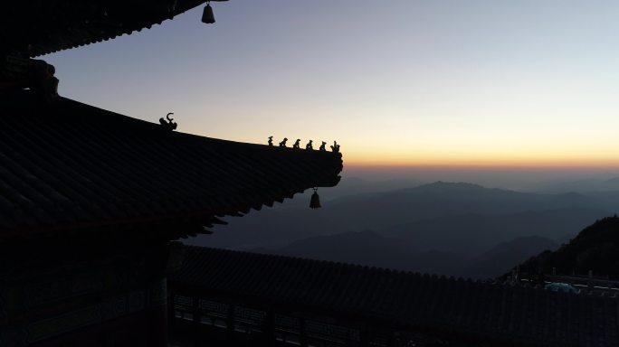 无人机拍摄远处橙色天际线映衬下的老君山顶庙宇建筑屋脊兽 远景（建筑）