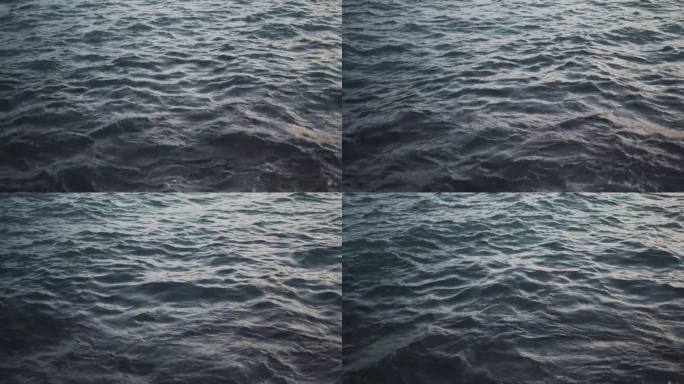 夕阳下，海浪轻轻拍打着宁静的海岸沙滩。