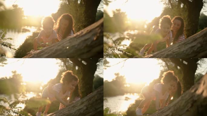 母亲正在帮助女儿爬树