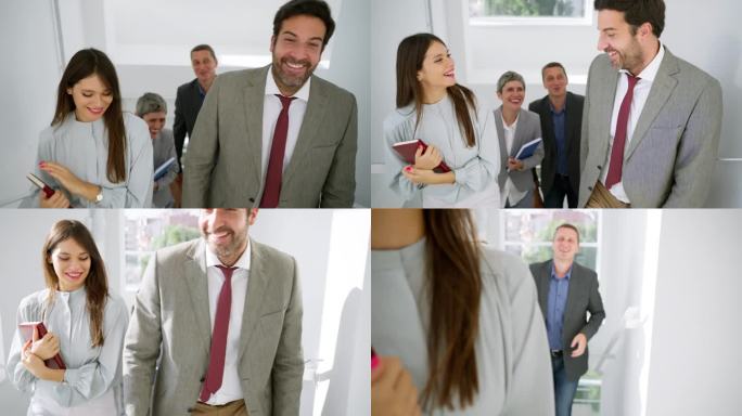 白种男女商人，边说边笑边上楼梯