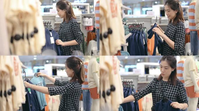 现代生活方式亚洲商业女性泰国/中国喜欢选择购买购物服装或衣服在百货商场背景在曼谷泰国