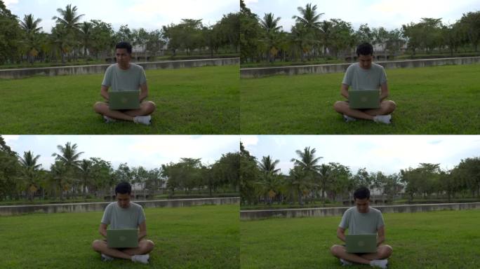 年轻人在公园用笔记本电脑