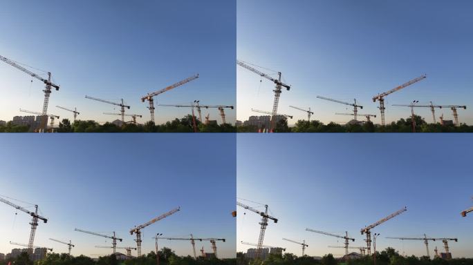 夕阳下城市建设塔吊林立