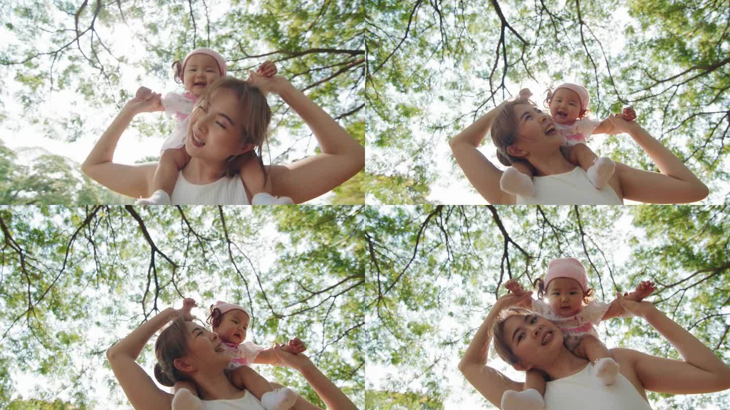 快乐的母亲和女儿一起享受美丽的大自然，呼吸新鲜的空气