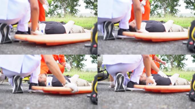 救护小组抢救一名车祸受害者的受伤人员