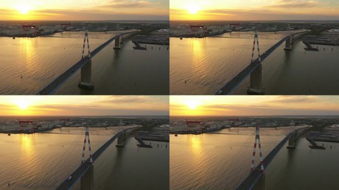 在公路上空飞行的法国斜拉桥。神奇的日出。圣纳泽尔大桥鸟瞰图，这座斜拉桥横跨法国卢瓦尔河