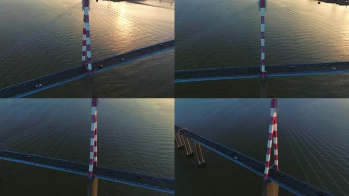 在公路上空飞行的法国斜拉桥。神奇的日出。圣纳泽尔大桥鸟瞰图，这座斜拉桥横跨法国卢瓦尔河