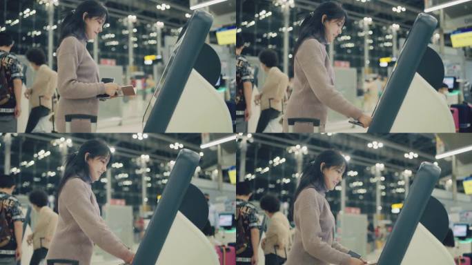 旅客在国际机场候机楼出发区自助值机办理登机手续。