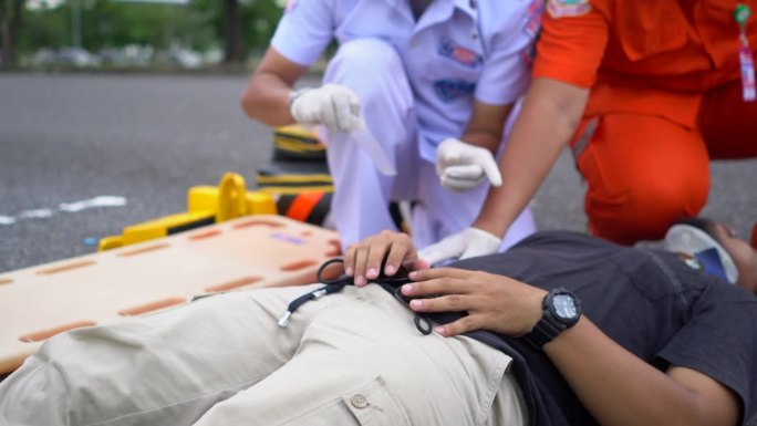 救护小组抢救一名车祸受害者的受伤人员