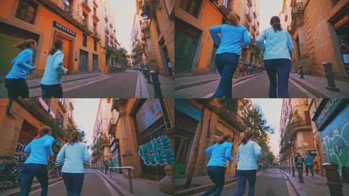 慢镜头的妇女慢跑在街道上的城市。女性朋友在建筑物中奔跑。他们过着积极的生活方式。