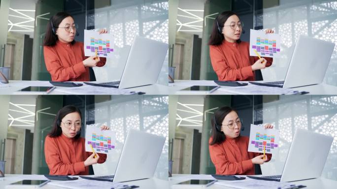 图为，一位亚洲女性经理坐在办公室的工作场所，用笔记本电脑进行视频会议