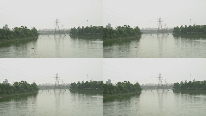 广角静止拍摄的一条大河与建筑物，桥梁，电线杆的背景