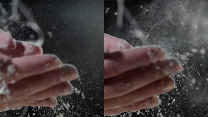面粉颗粒在面包师拍手后动态散开，粉状云雾在黑暗背景下翻滚，突显烹饪工作空间。