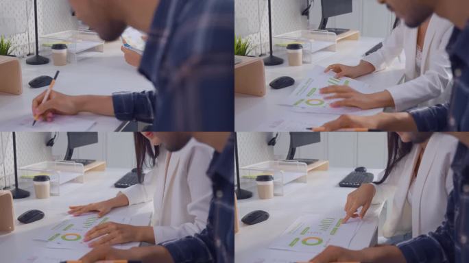 年轻有魅力的商人和女商人在办公室工作。吸引员工进行头脑风暴和会议，在工作场所计划和讨论项目。现代同事