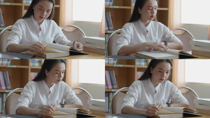 女性的手在翻书。成人学生读书