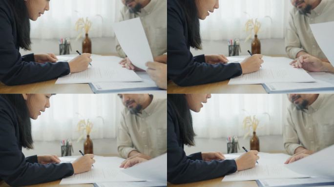 一位女性财务顾问在一对夫妇家中向他们指出重要文件的特写。