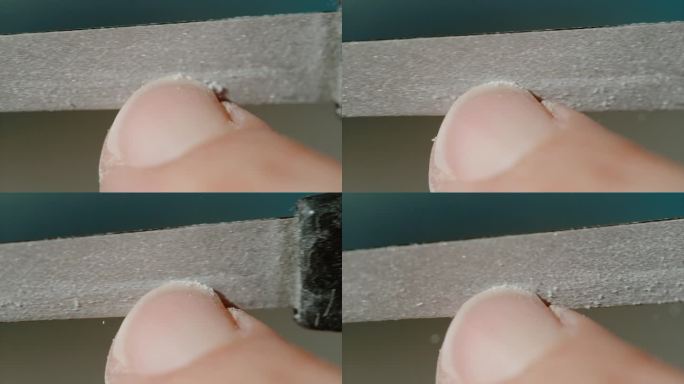 微距镜头:一个年轻女子用粗指甲锉指甲的详细特写镜头