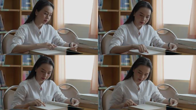 女性的手在翻书。成人学生读书