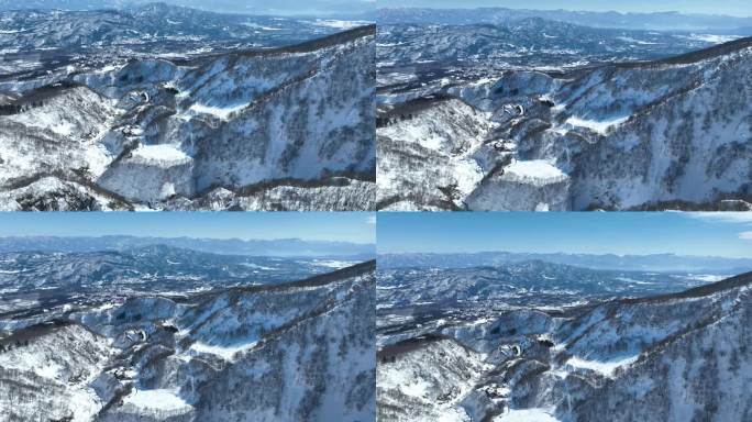 无人机从白雪皑皑的山顶上拍摄，镜头向前推进，向上平移。日本火山myōkō是位于名古屋人山国立公园地区
