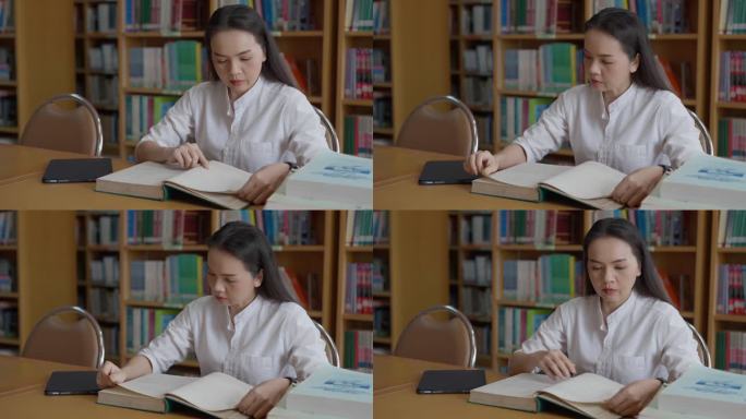女性的手在翻书。成人学生读书