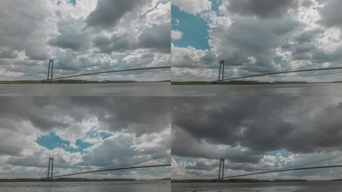 多云的天空，在一个高大的悬索桥上的一条大河，HDR