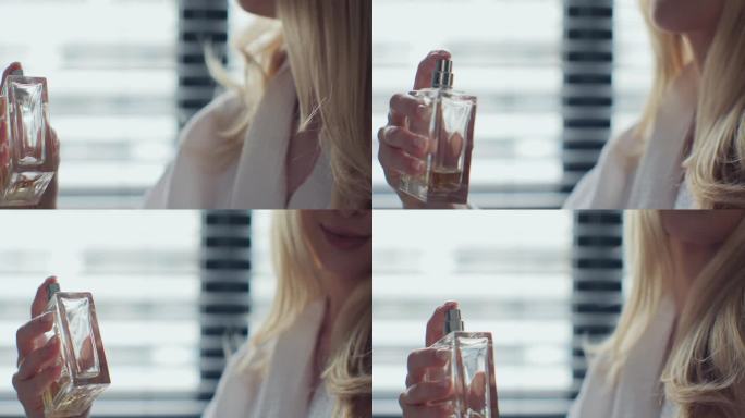 一个女人从瓶子里喷香水的特写镜头。漂亮女孩用香水瓶。化妆品香水瓶。