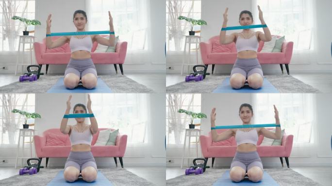 健康的亚洲女运动员在健身房做平板支撑锻炼身体。强壮的女运动员在家做增肌重量训练。保健动机概念