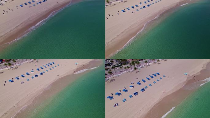 优雅的视觉空中无人机拍摄的海滩和沙滩与平静的海水，蓝色的海水，蓝天棕榈树在佛罗里达州劳德代尔海滩