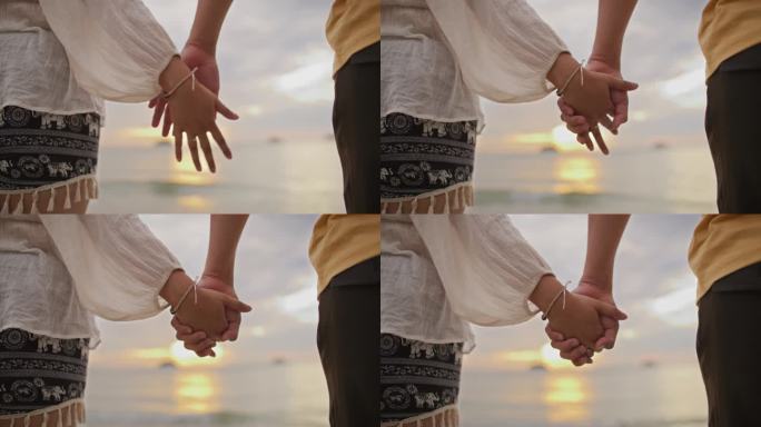 一对情侣手牵手在沙滩上