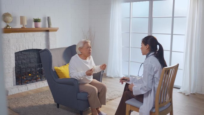 亚洲护理护士检查和倾听老年压力妇女患者。有吸引力的专业护理妇女的支持，给予建议和咨询老年人，成熟的祖