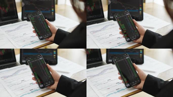 股票交易者在交易应用程序上研究股票市场