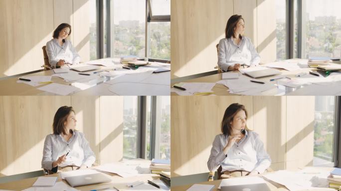 女人因一天的辛苦工作和工作失败而疲惫不堪。办公室里一个年轻漂亮的黑发女人的画像。