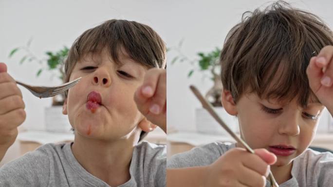 用餐时间的乐趣-小男孩喜欢像卡通人物一样吃意大利面