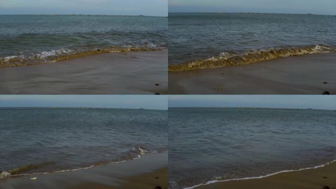 大海，蓝天，干净的沙滩，浪花拍打着沙滩