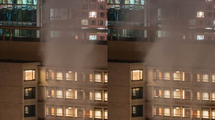 夜晚烟雾暖气与窗灯的都市风光