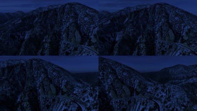 夜间冬季山脉公路航拍雪景，昼夜交替。
