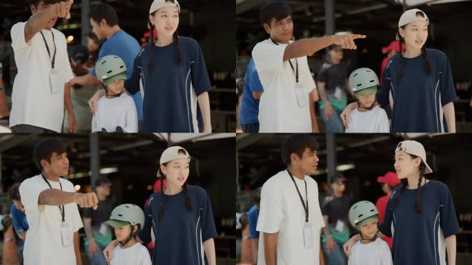 成熟的男性教练正在指向滑板公园，引导两姐妹练习滑板。