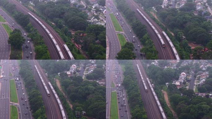 从空中俯瞰两列长岛铁路列车在阴天行驶。无人机镜头向下倾斜，推进并向上倾斜以跟随驶向纽约市的列车。
