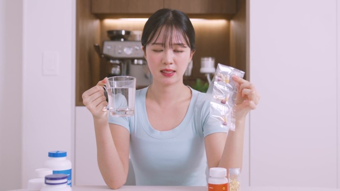 独自生活 - 一位年轻女性双手握着药品包装，感到疲惫不堪 / 韩国