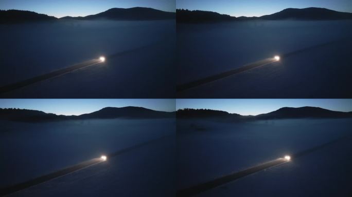 安静的冬季风景，孤独的道路上汽车的航拍照明。