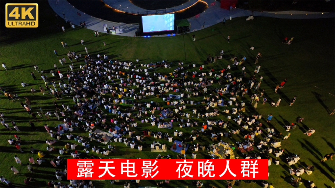 4K航拍夜晚乘凉的人群看露天电影草坪观影