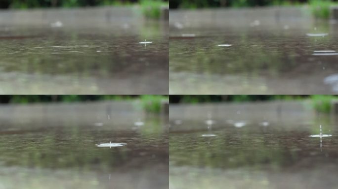 雨滴落在地面积水上溅起水花慢镜