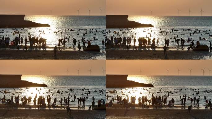 夕阳海滩人群剪影