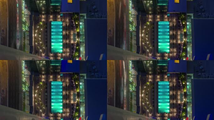 多哈，卡塔尔 - 2024年10月25日：夜晚现代建筑环绕下的迷人灯光泳池的鸟瞰图。