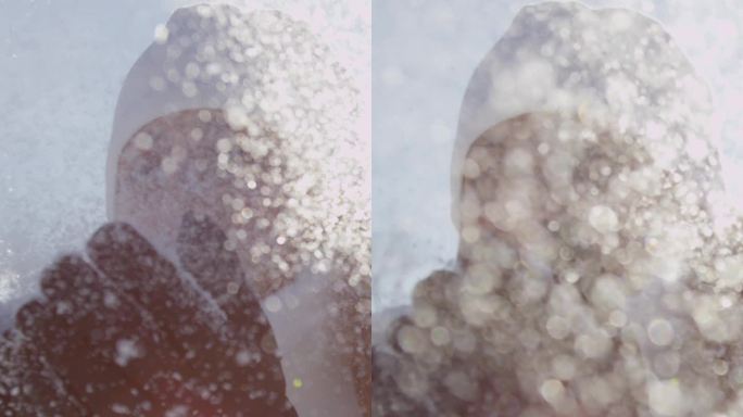 慢动作：年轻女性在阳光下吹雪花