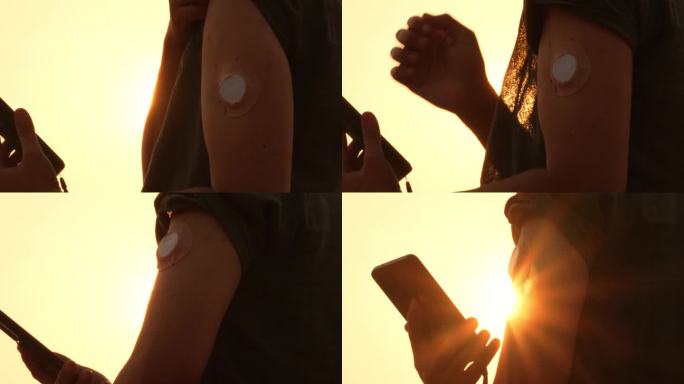 年轻男子在日落时用智能手机检查连续血糖监测仪的血糖。