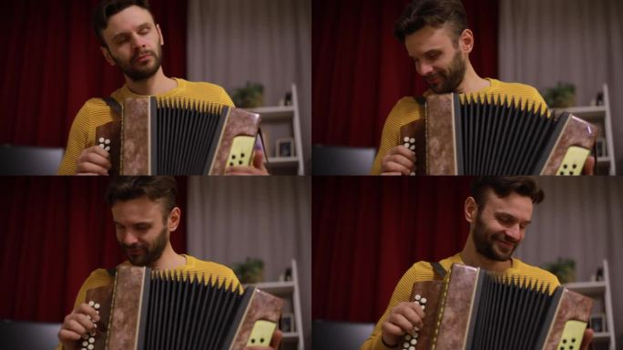 年轻男子穿着黄色毛衣，在红色窗帘背景下室内演奏手风琴，表情沉思，适合音乐和生活方式项目的温馨艺术库存