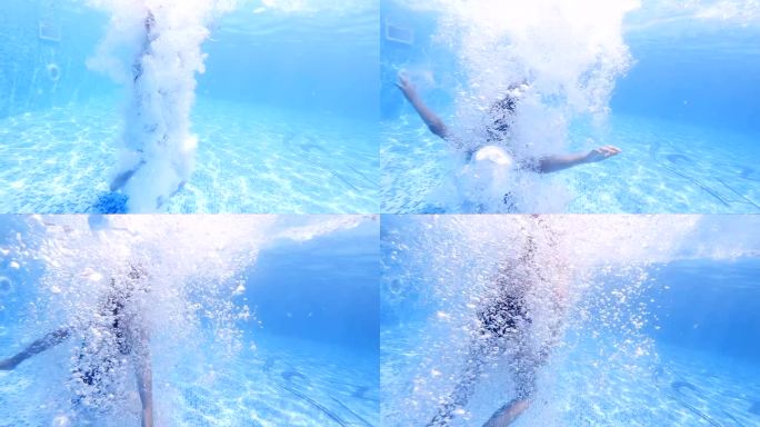 有趣的孩子游泳，从池边跳入水中，慢动作潜入水下。