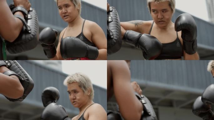 一位充满决心的亚洲女性残疾人绕过教练手中的垫子。