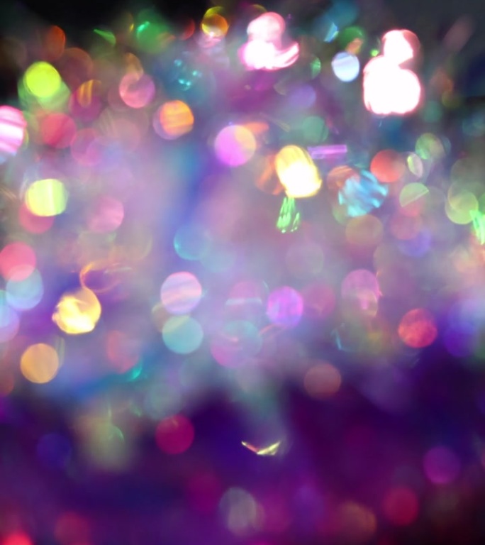 色彩斑斓的抽象背景，带有散景效果。光线反射的表面。城市灯光、迪斯科、夜总会或壁纸动画。生动大胆的色彩